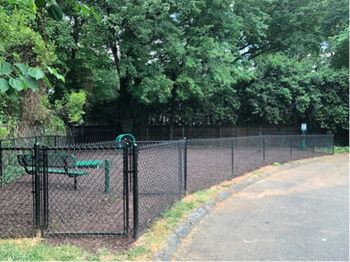 A park with a bench and a fence
